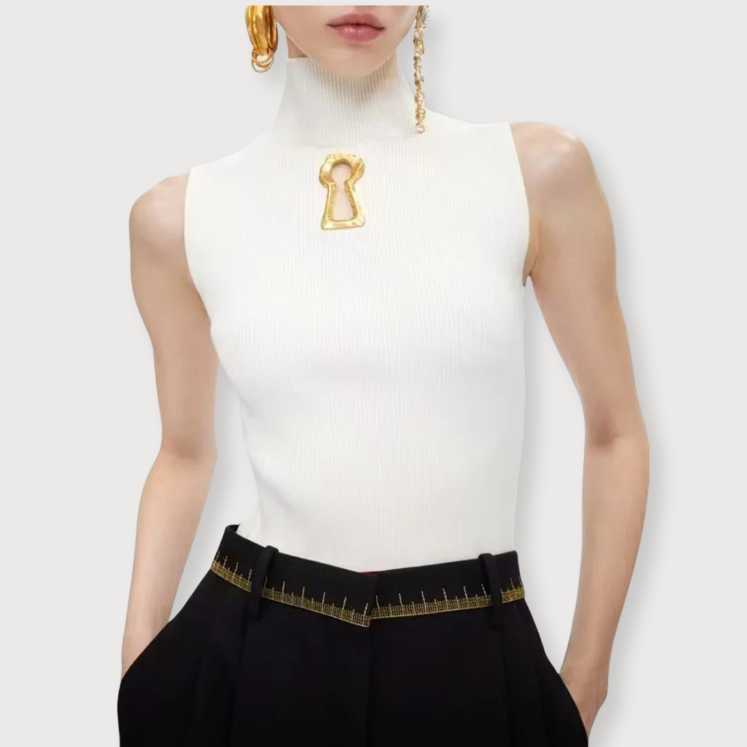 A woman wearing a trendy top with long sleeves . Golden Atelier