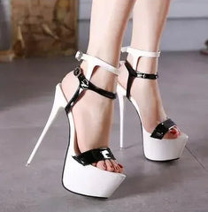 White high-heeled platform shoes with black accents on a neutral background