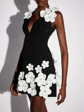 A woman modeling a 3D floral mini dress with delicate beading.