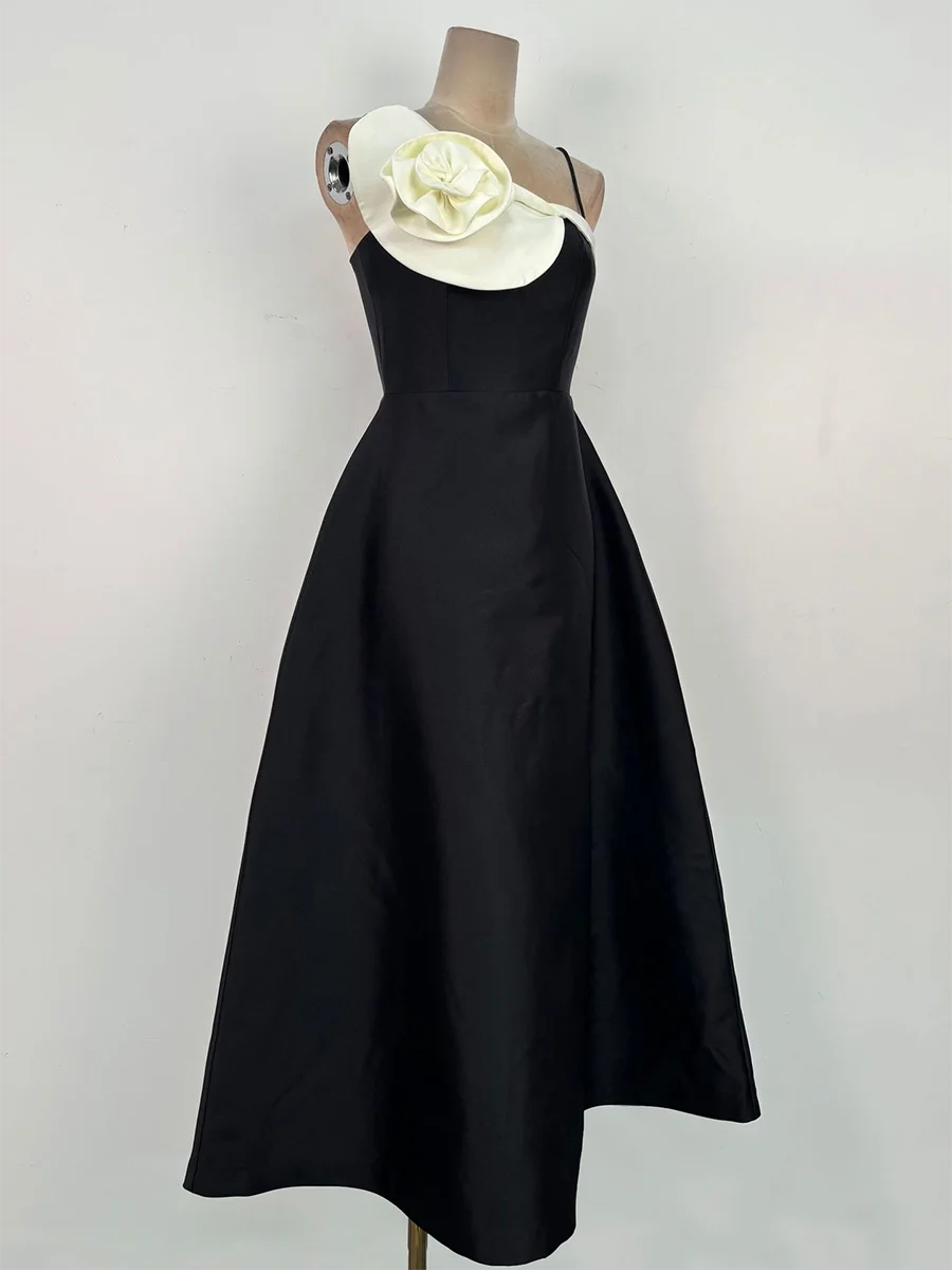 Elegant black A-line dress styled with a dimensional neckline accent