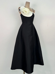 Elegant black A-line dress styled with a dimensional neckline accent
