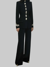 Black embellished stand collar jacket and wide leg pants suit worn by a model