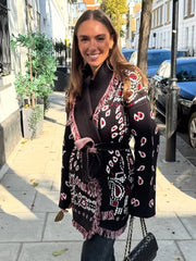 Woman wearing a patterned scarf on a city street