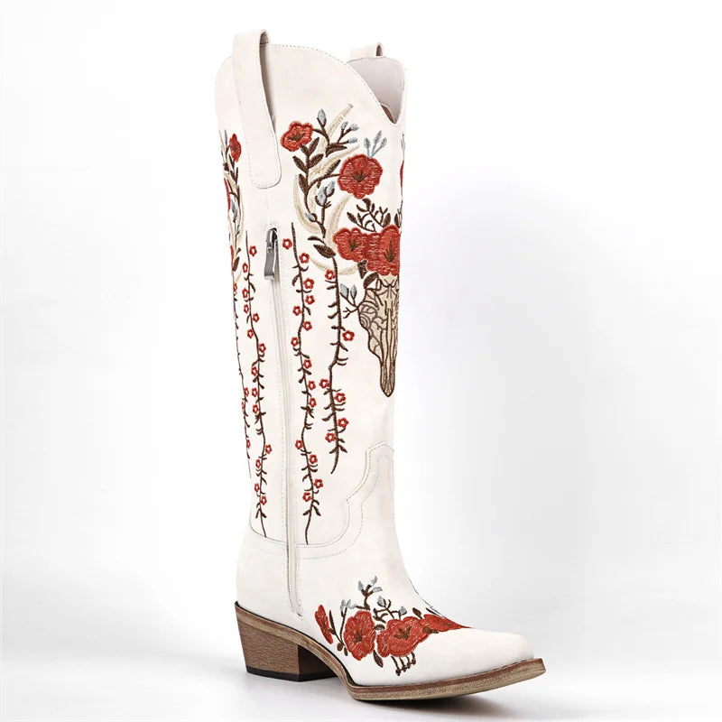 White cowboy boot with red floral embroidery on a white background
