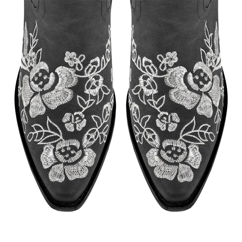 Close-up of floral embroidery on pointed toe boots