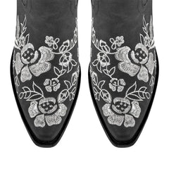Close-up of floral embroidery on pointed toe boots