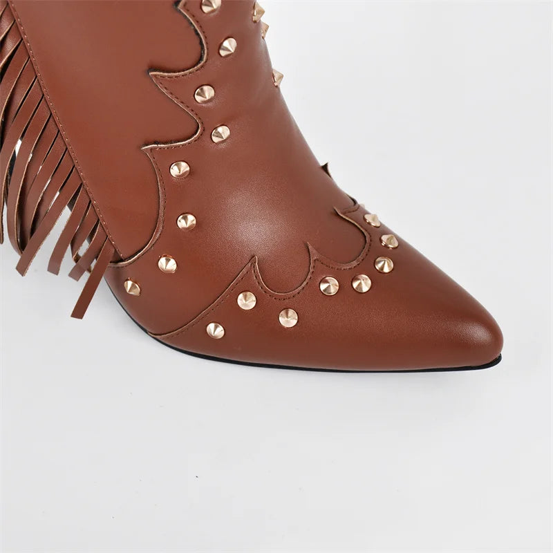 Close-up of the pointed toe on brown faux leather ankle boots with stud embellishments.