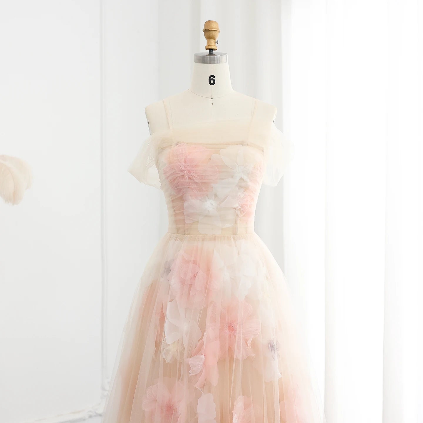 Pastel floral dress on a mannequin against a white background