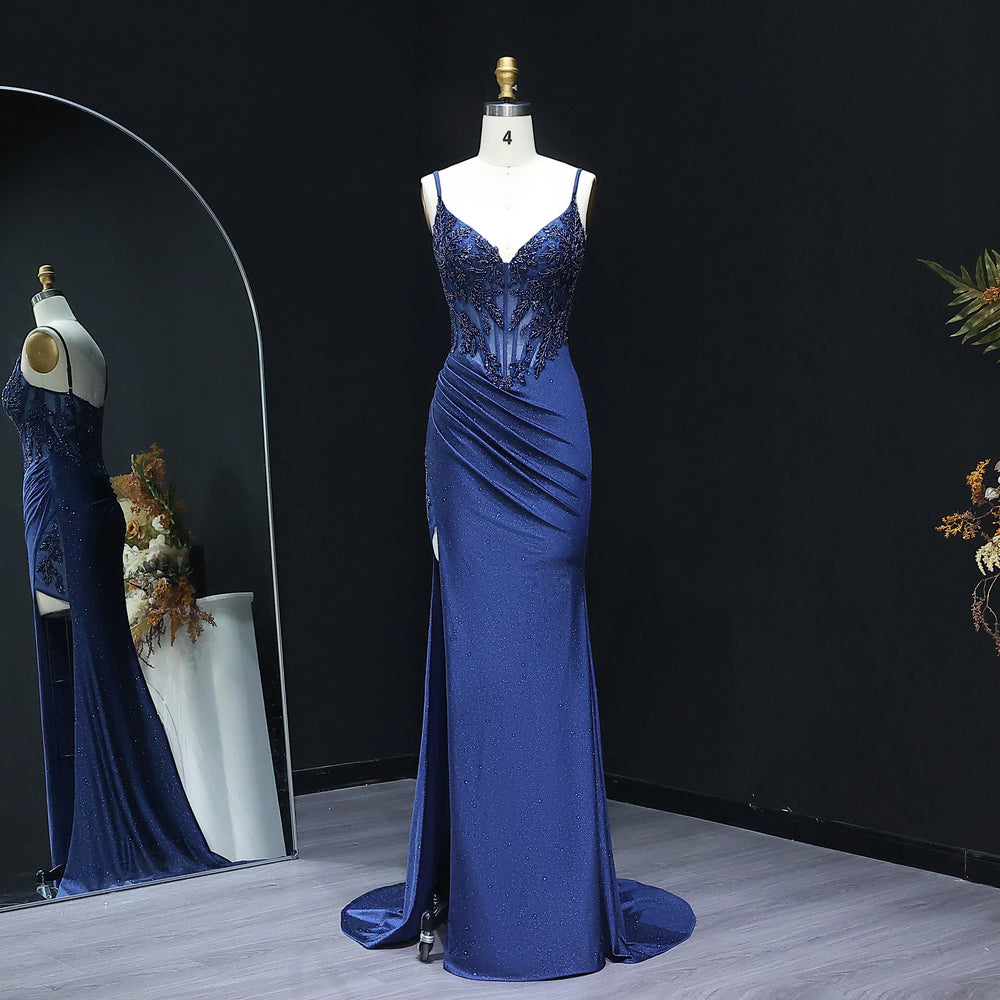Blue evening gown on a mannequin against a black background