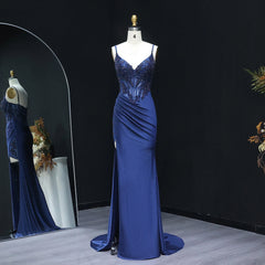 Blue evening gown on a mannequin against a black background