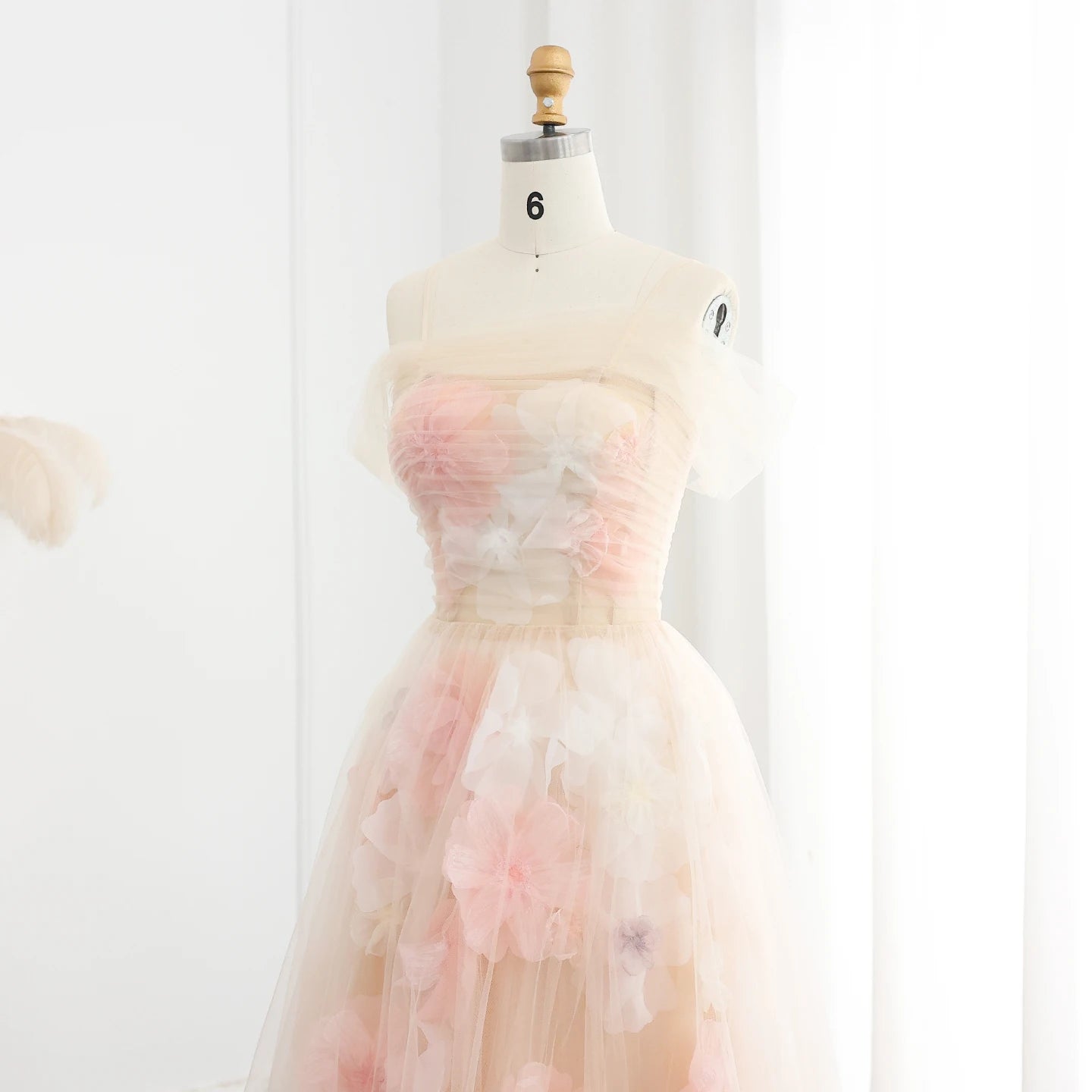 Pastel-colored dress on a mannequin against a white background