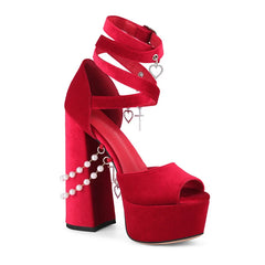 Red high-heeled shoe with heart-shaped decorations on a white background