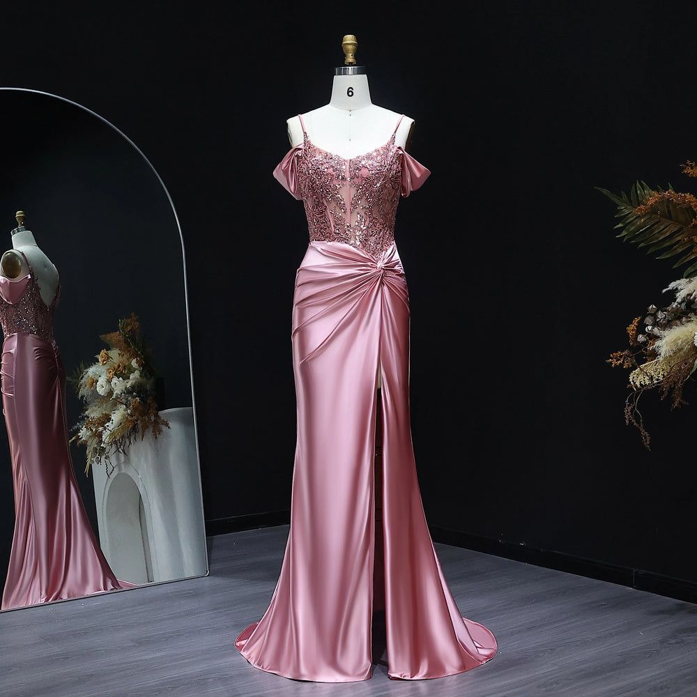 Pink evening gown on a mannequin against a dark background