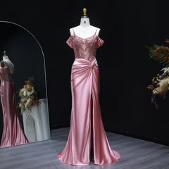Pink evening gown on a mannequin against a dark background