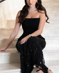 Black strapless sequin A-line prom gown with shawl.