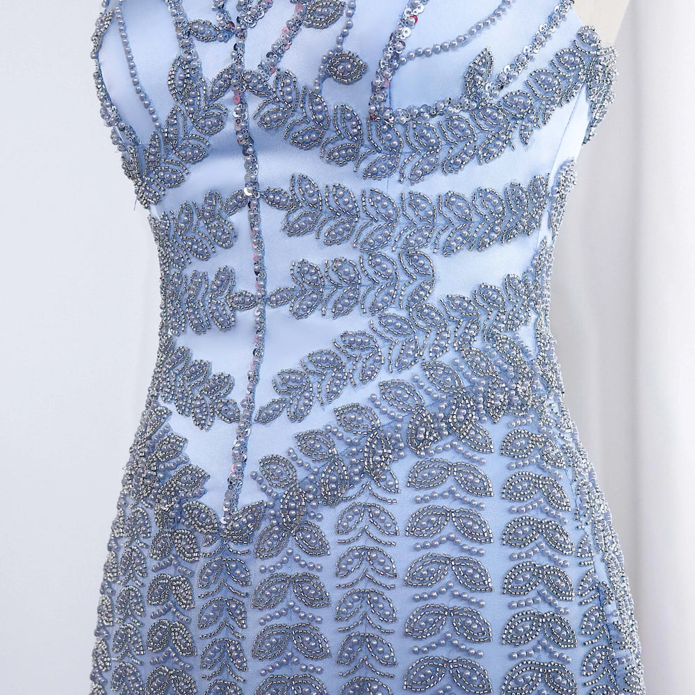 Blue beaded dress with intricate patterns on a white background