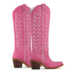 Pair of pink western boots with white heart embroidery, showing heel