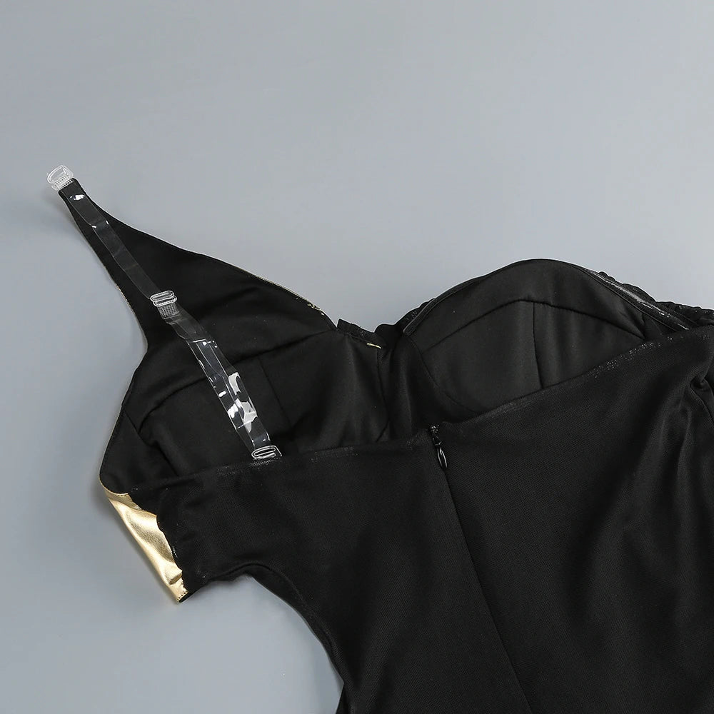 Black outfit with gold accents on a gray background