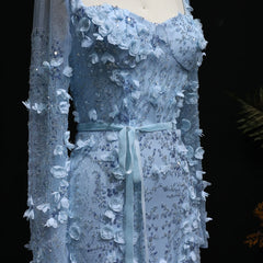Blue lace dress on a mannequin against a dark background