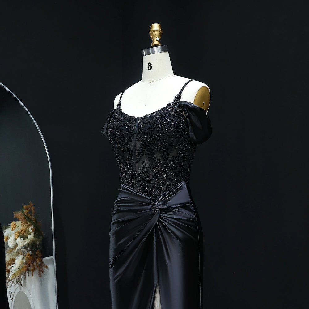 Black evening gown on a mannequin against a dark background