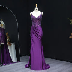 Purple evening gown on a mannequin against a black background