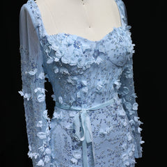 Blue lace dress with floral details on a mannequin against a black background