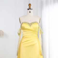 Yellow evening gown with embellishments on a mannequin against a white background