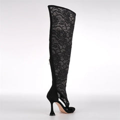 Side view of black lace over the knee stiletto boots.