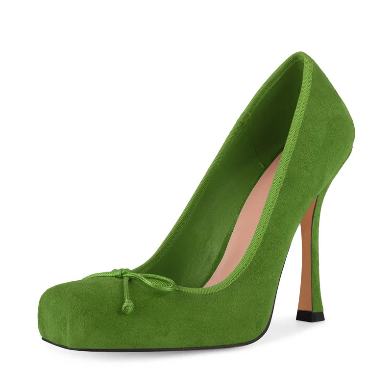 Green high-heeled shoe on a white background