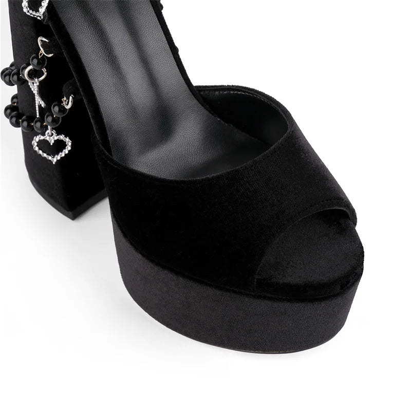 Black open-toe high-heeled shoe with platform on a white background