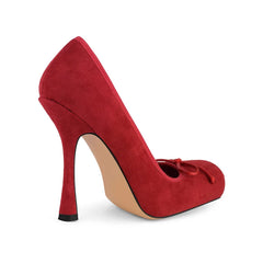 Red high-heeled shoe with a bow on a white background