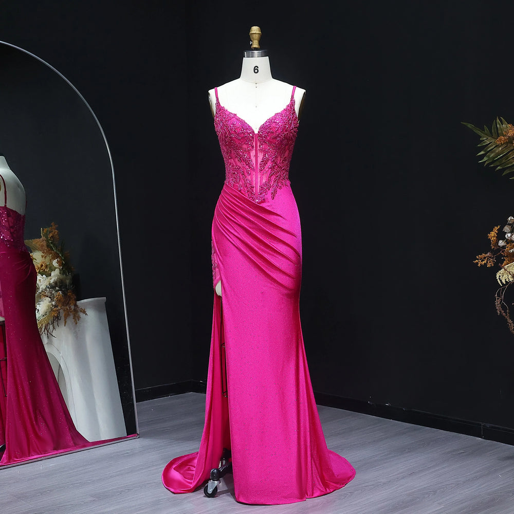 Pink evening gown on a mannequin against a black background
