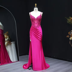 Pink evening gown on a mannequin against a black background