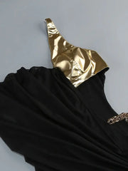 Black dress with gold top on a gray background