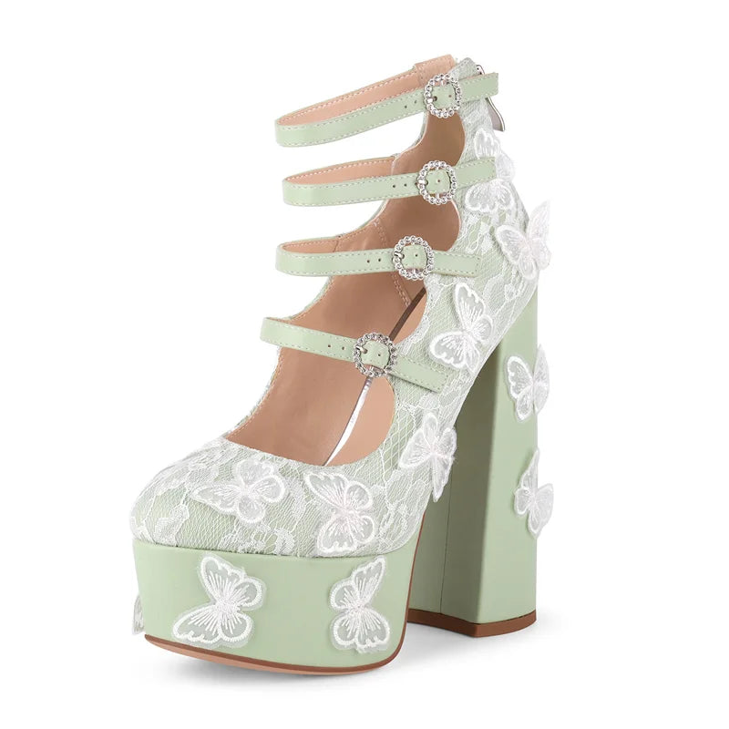Light green high-heeled shoe with white lace and butterfly details on a white background