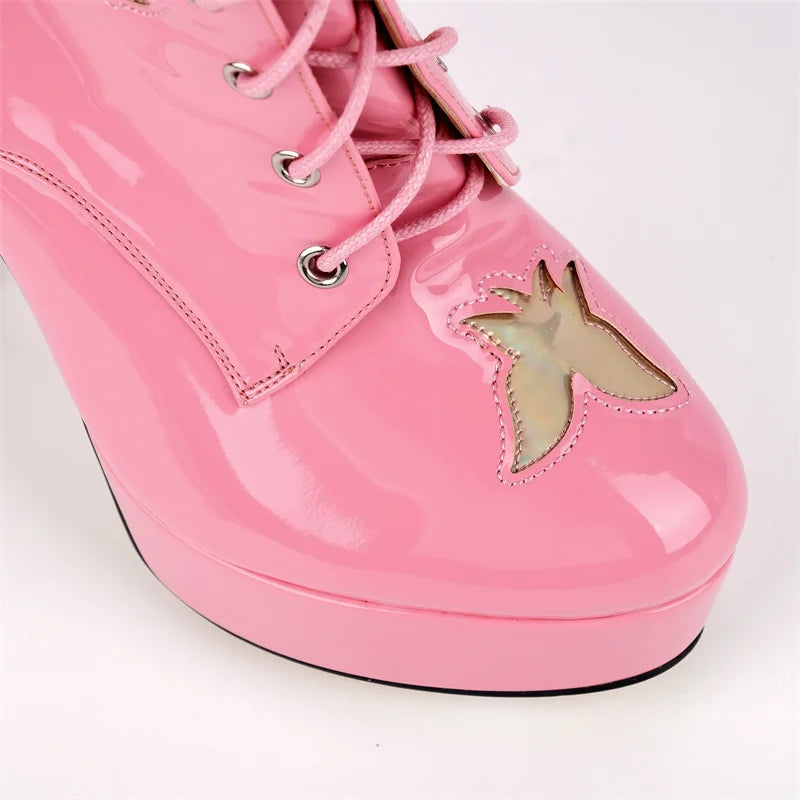 Detail of the toe area on pink patent leather lace-up boots with butterfly cutout