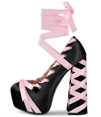 Black high-heeled shoes with pink ribbons and geometric patterns on a white background