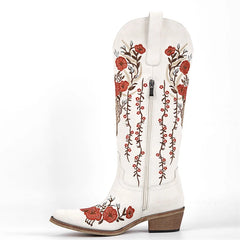 White cowboy boot with red floral embroidery on a white background