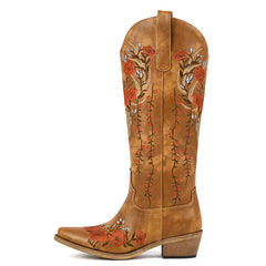 Brown cowboy boot with floral embroidery on a white background