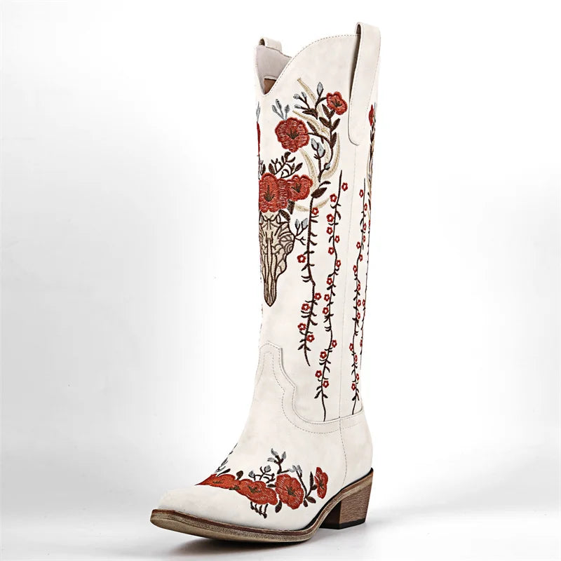 White cowboy boot with red floral embroidery on a white background