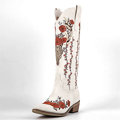White cowboy boot with red floral embroidery on a white background