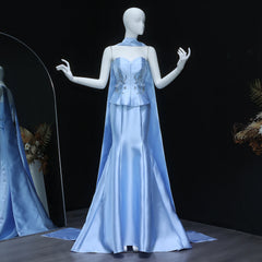 Mannequin wearing a light blue evening gown with intricate detailing on a dark background