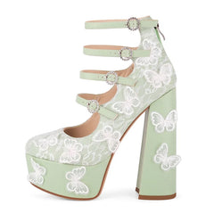 Light green high-heeled shoes with butterfly lace design on a white background