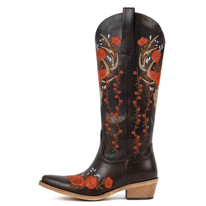 Black cowboy boot with red floral embroidery on a white background