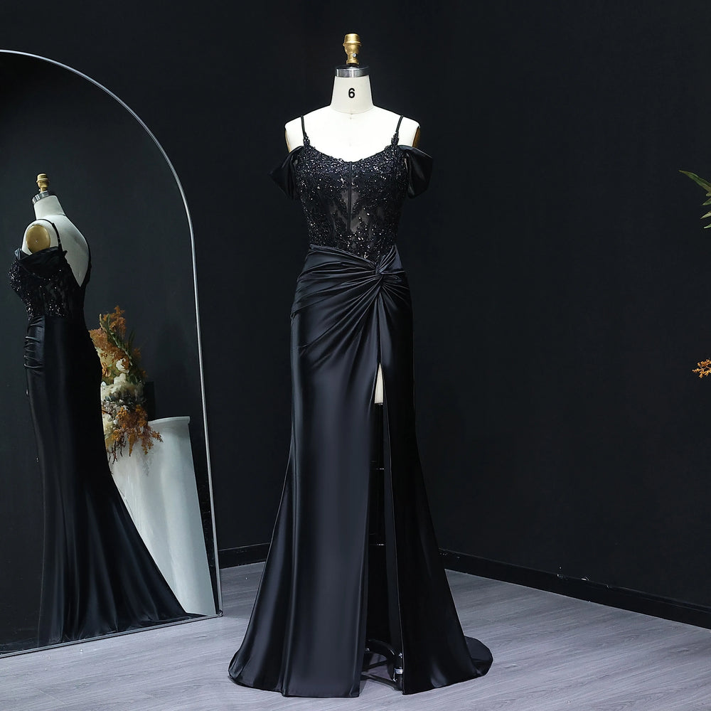 Black evening gown on a mannequin against a dark background