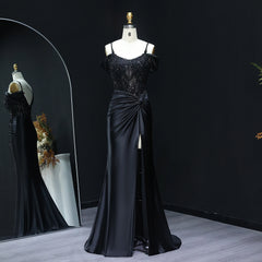 Black evening gown on a mannequin against a dark background