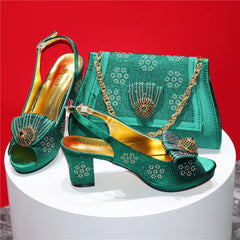 Green high-heeled shoes with gold accents and matching handbag on a white pedestal against a red background