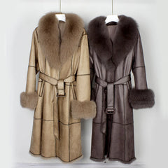 Two fur-coated coats with fur collars and cuffs on hangers against a white background.