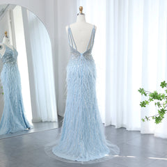 Light blue evening gown on a mannequin with a mirror reflection in a room with white curtains.