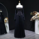 Black evening gown on a mannequin against a dark background with decorative elements.
